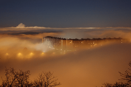 a condominium building covered in night fog